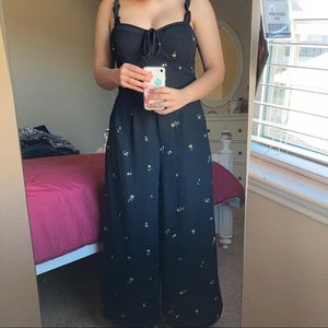 Black jump suit with yellow floweres